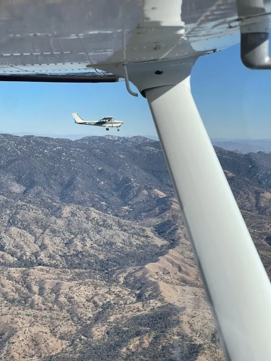 Training aircraft in formation flight over the San Bernardino Mountains during a density-altitude lesson