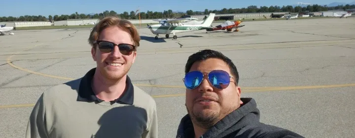 Student pilot celebrating with their CFI after a solo flight
